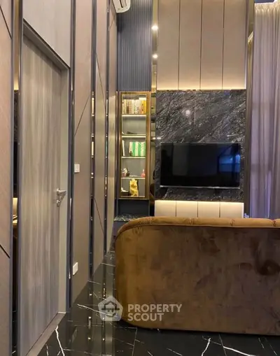 Luxurious living room with modern design, featuring marble accents and elegant lighting.