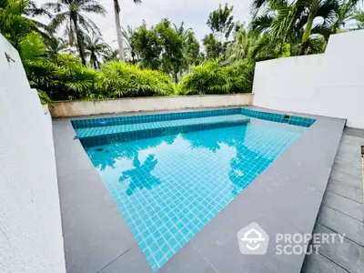 Luxurious private pool surrounded by lush greenery and modern design