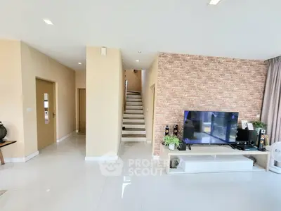 Modern living room with sleek TV setup and stylish brick accent wall