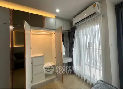 Modern bedroom with open wardrobe and balcony view, featuring sleek design and ample natural light.