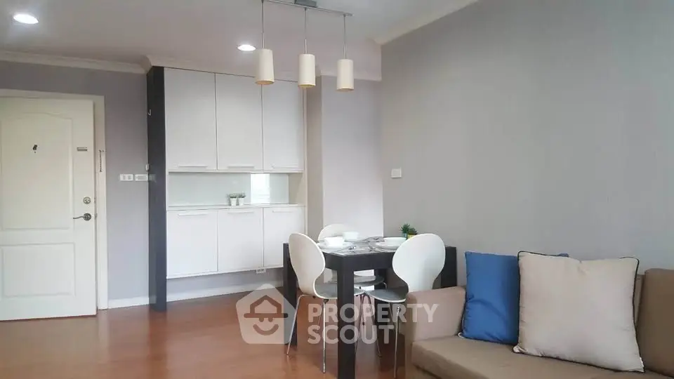 Modern living room with stylish furniture and dining area in a cozy apartment.