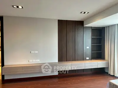 Modern living room with sleek wooden paneling and built-in shelving