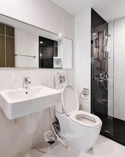Modern bathroom with sleek fixtures and glass shower enclosure