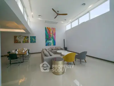 Spacious modern living room with high ceilings and colorful artwork