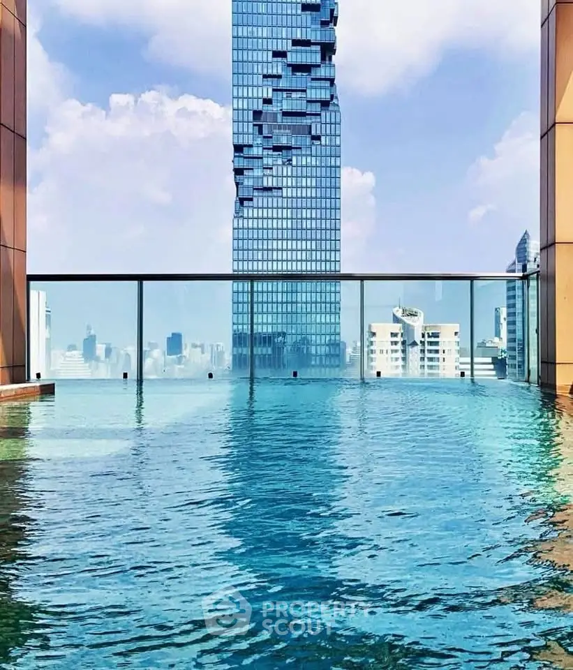 Stunning rooftop pool with city skyline view in luxury high-rise building.