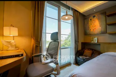Cozy bedroom with modern decor and large window offering scenic views