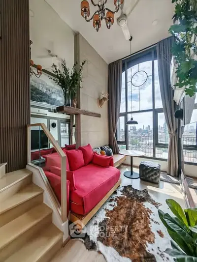 Stylish living room with vibrant red sofa and panoramic city view