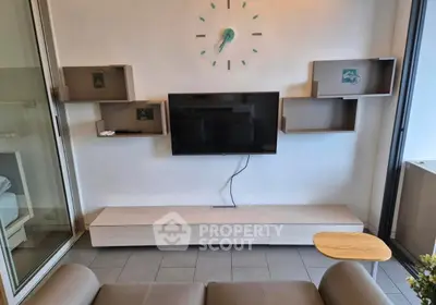 Modern living room with wall-mounted TV and stylish shelving