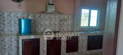 Charming kitchen with gas stove and tiled backsplash in cozy home