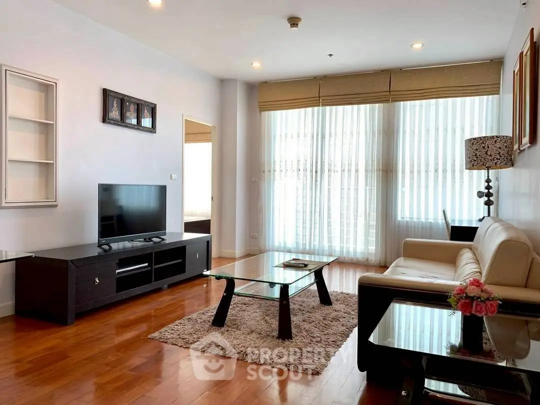 Spacious living room with modern furniture and large windows in a stylish apartment.