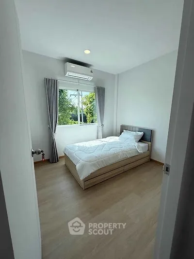 Bright minimalist bedroom with large window and modern decor