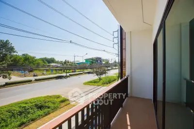 Spacious balcony with scenic road view and lush greenery