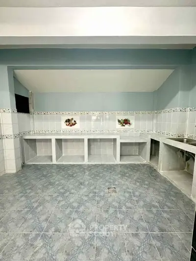 Spacious tiled kitchen with open layout and decorative backsplash, ideal for culinary enthusiasts.