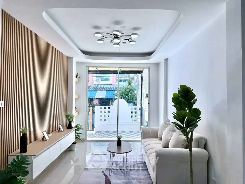 Modern living room with elegant decor and large window view.