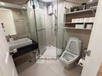 Modern bathroom with glass shower and sleek fixtures