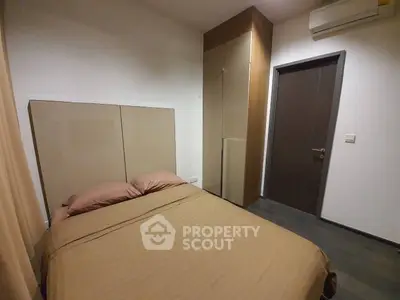 Cozy bedroom with modern design and air conditioning, featuring a comfortable bed and sleek wardrobe.