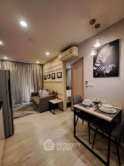 Modern living room with dining area, stylish decor, and cozy ambiance in a contemporary apartment.
