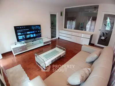 Spacious living room with modern furniture and entertainment setup
