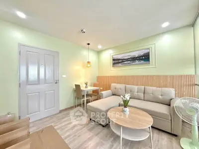 Modern living room with cozy beige sofa, stylish decor, and dining area in open layout.