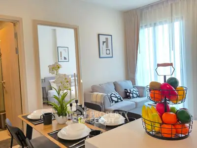 Modern living room with dining area, stylish decor, and natural light