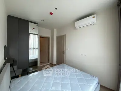Modern bedroom with air conditioning and mirrored wardrobe in a stylish apartment.
