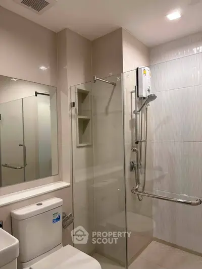 Modern bathroom with glass shower enclosure and sleek fixtures