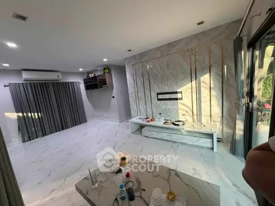 Spacious modern living room with marble accents and large windows
