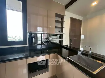 Modern kitchen with sleek cabinetry and built-in appliances in a contemporary apartment.