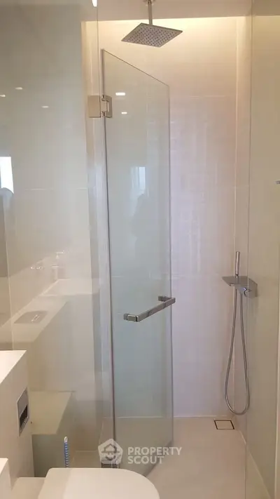 Modern bathroom with glass shower enclosure and sleek fixtures