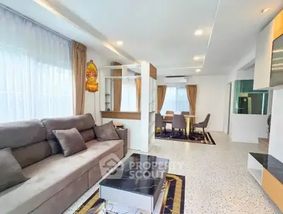 Spacious modern living room with elegant decor and ample natural light.