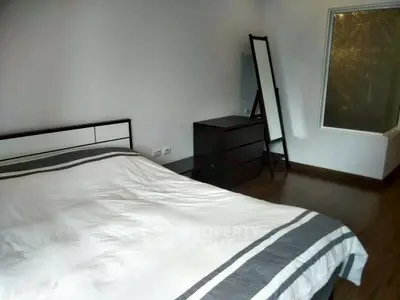 Cozy bedroom with modern decor and stylish furnishings, perfect for relaxation.