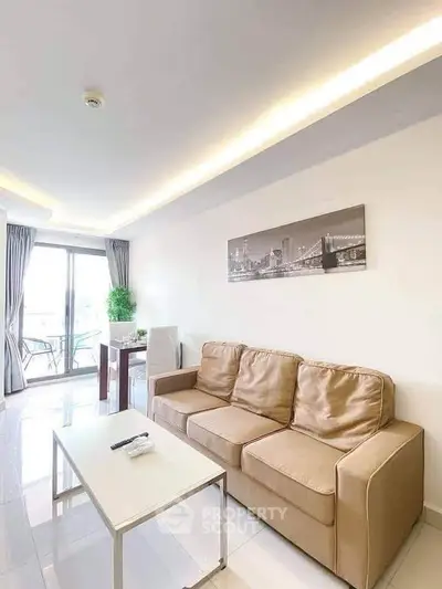 Modern living room with beige sofa and balcony view in stylish apartment.