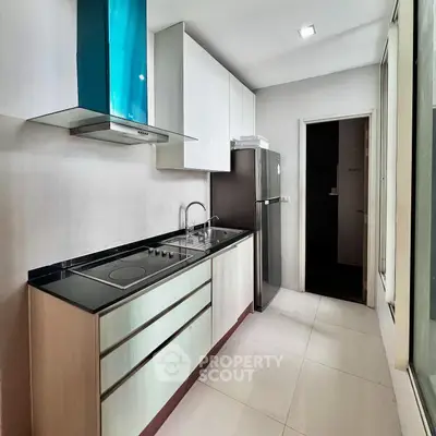 Modern kitchen with sleek cabinets and stainless steel appliances in a bright, spacious layout.