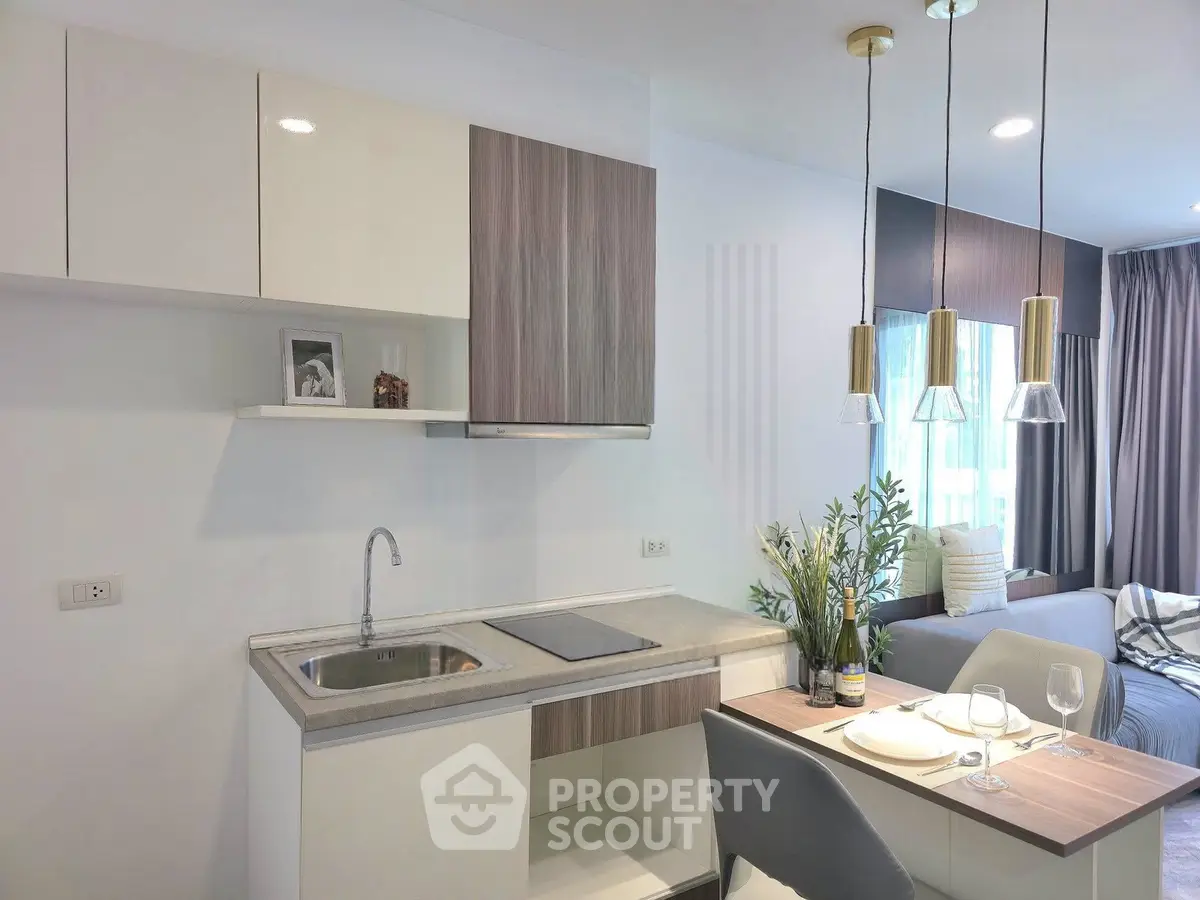Modern kitchen and dining area with sleek design and natural light
