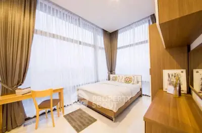 Modern bedroom with large windows and elegant decor