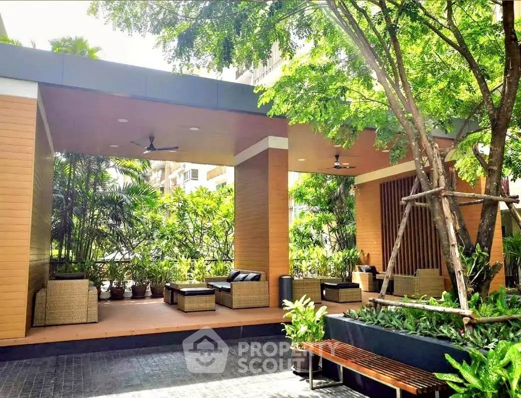 Luxurious outdoor seating area with lush greenery and modern design