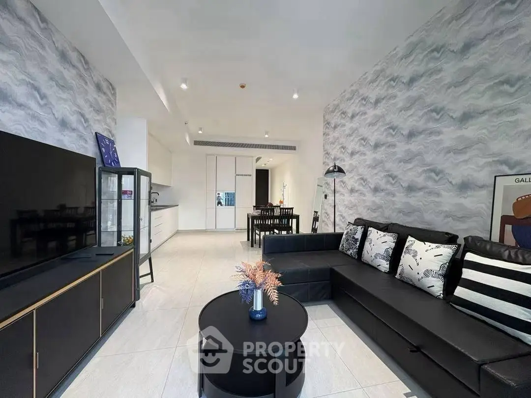Modern living room with stylish decor and open kitchen layout in a contemporary apartment.