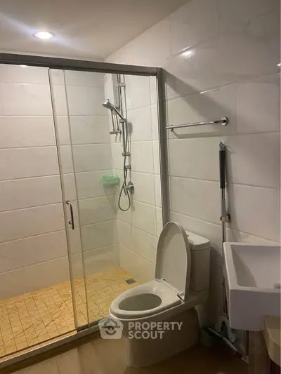 Modern bathroom with glass shower enclosure and sleek fixtures