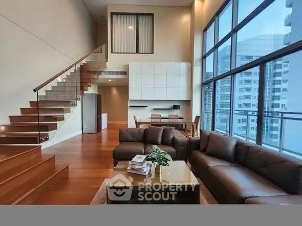 Luxurious modern living room with high ceilings and large windows offering city views.