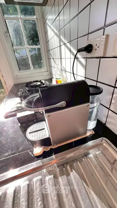 Modern kitchen with espresso machine and sleek black countertop