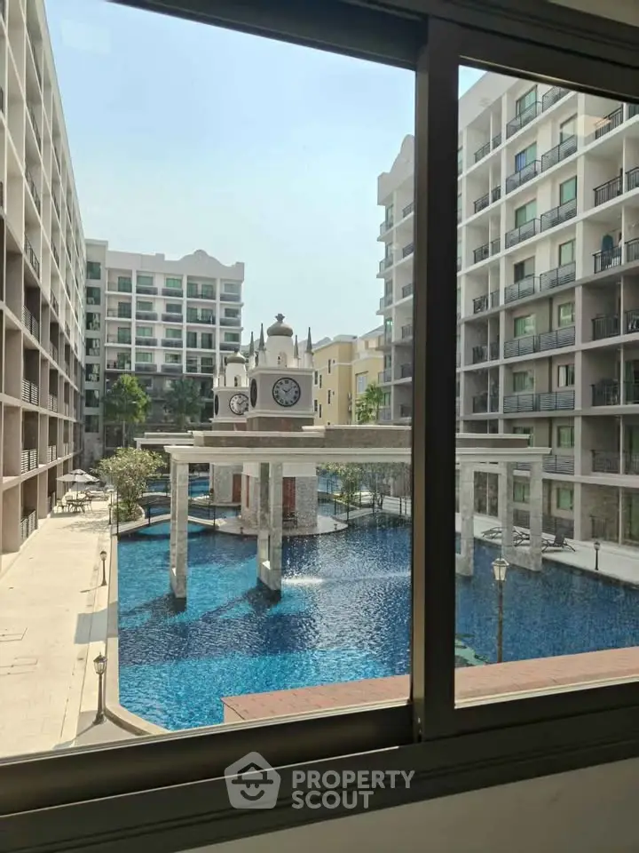 Luxurious apartment complex with stunning pool view and elegant architecture.