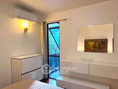 Modern bedroom with balcony access and stylish decor
