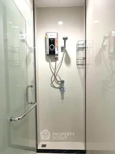 Modern bathroom shower area with glass enclosure and water heater