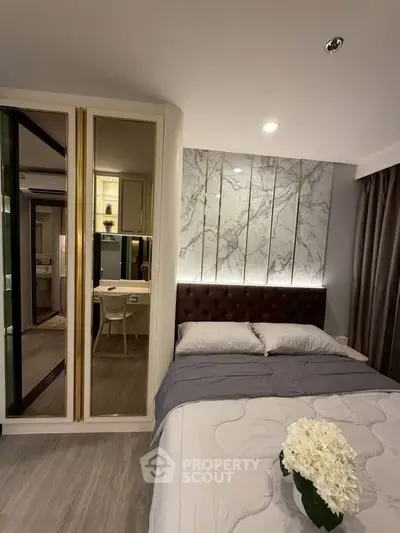 Luxurious bedroom with elegant decor and modern furnishings, featuring a stylish bed and chic lighting.