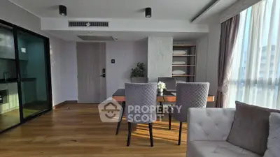 Spacious modern living room with elegant dining area and natural light