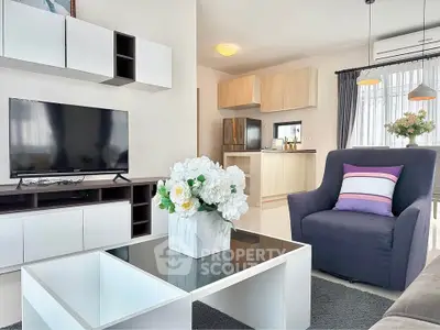 Modern living room with stylish decor and open layout, featuring a sleek TV unit and cozy seating area.