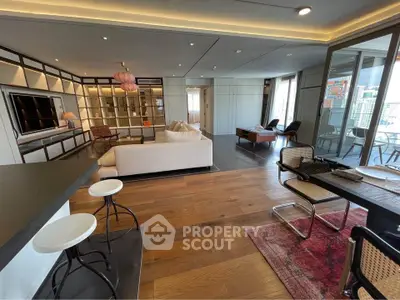 Luxurious open-plan living room with modern decor and city view balcony.