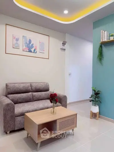 Modern living room with stylish sofa, elegant coffee table, and chic wall decor in a cozy apartment.