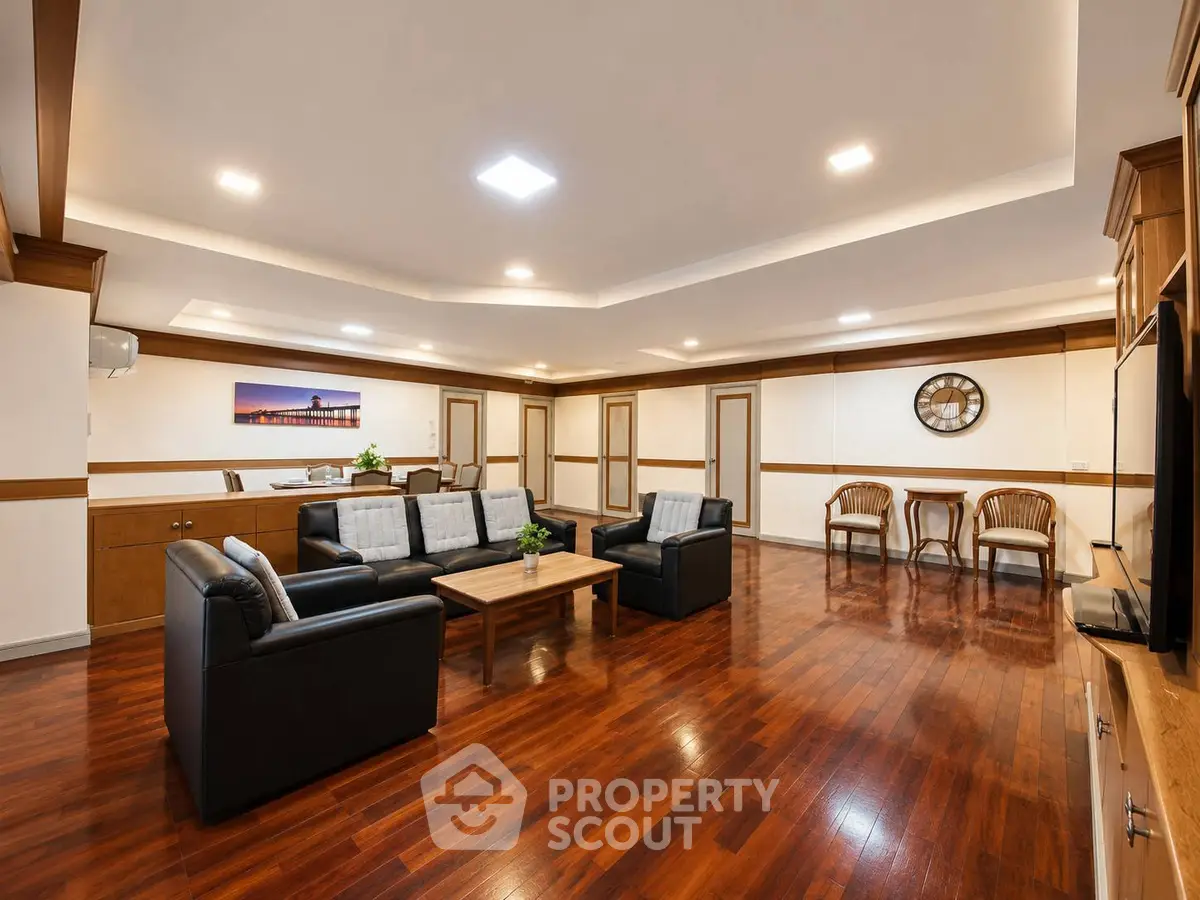 Spacious living room with elegant wooden flooring and modern furniture