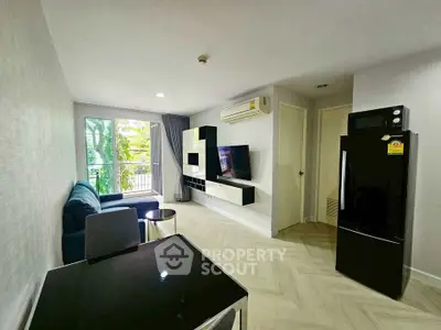 Modern living room with sleek furniture and balcony view in a stylish apartment.